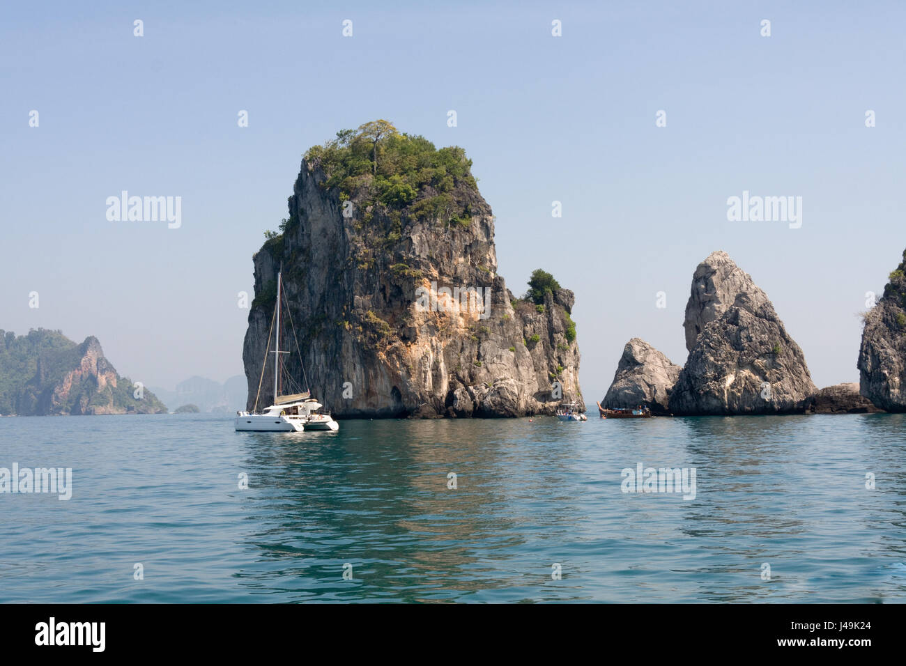 Catamaran and limestone outcrops, Krabi, Thailand Stock Photo