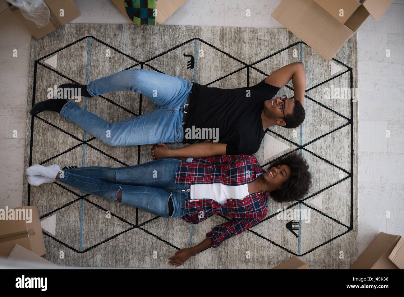 Top view of attractive young African American couple moving, holding ...
