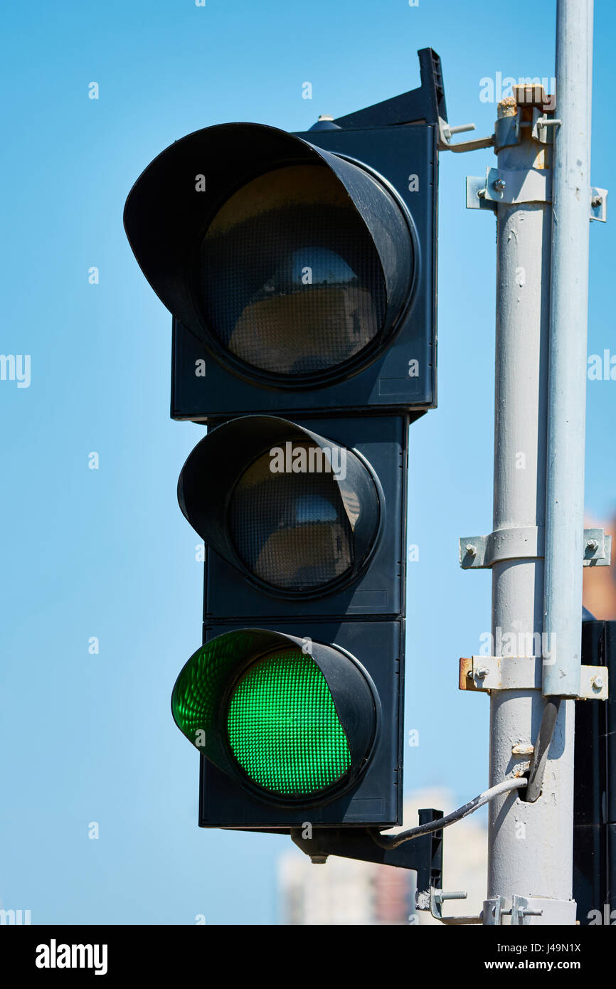 Green color on the traffic light with a beautiful blue sky in ...