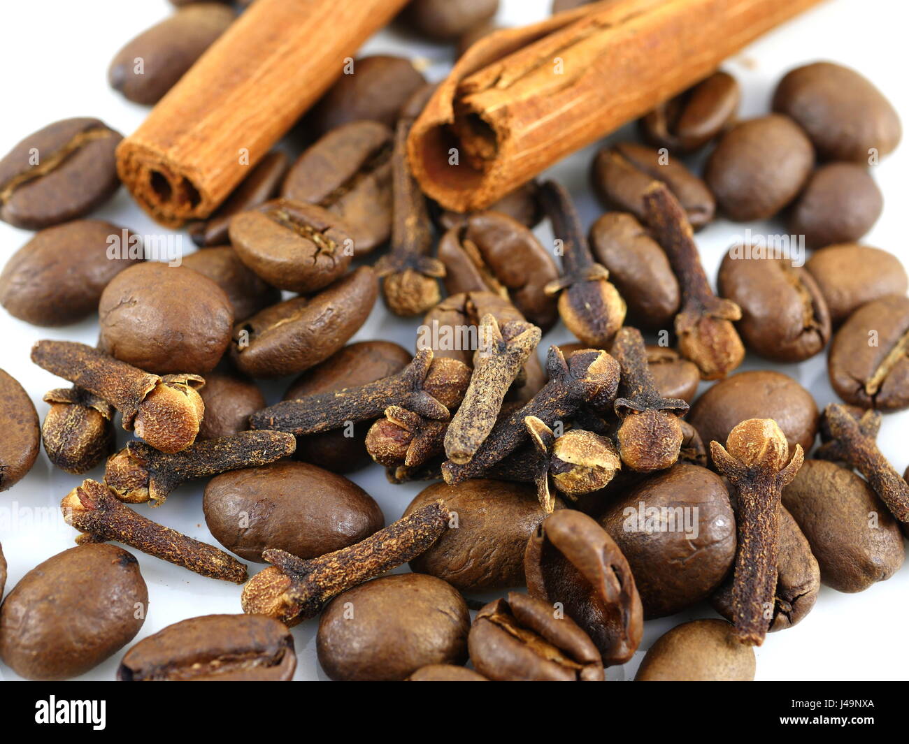 roasted coffee cinnamon and cloves on white background Stock Photo Alamy