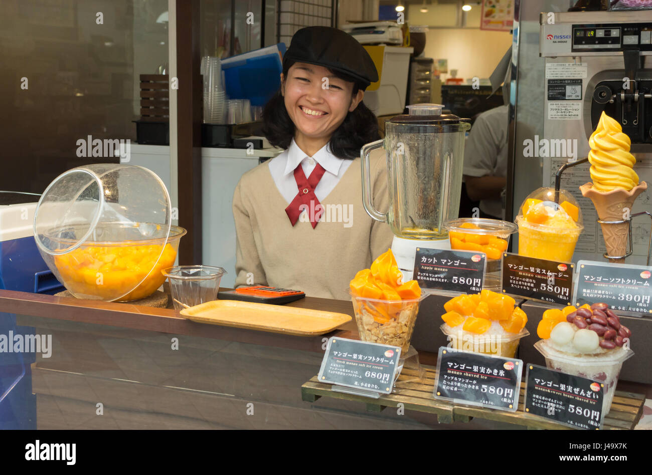 Okinawa, Japan March 24th, 2017 A japanese girl is selling mango
