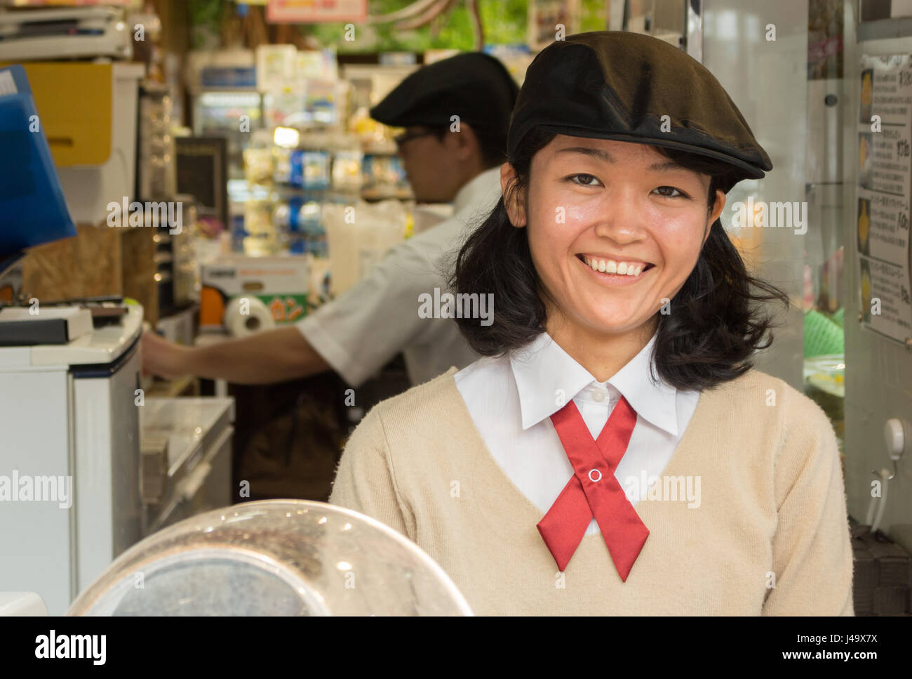 Okinawa, Japan - March 24th, 2017: Portrait of a japanese employee smiling, working at a mango ice-cream store Stock Photo