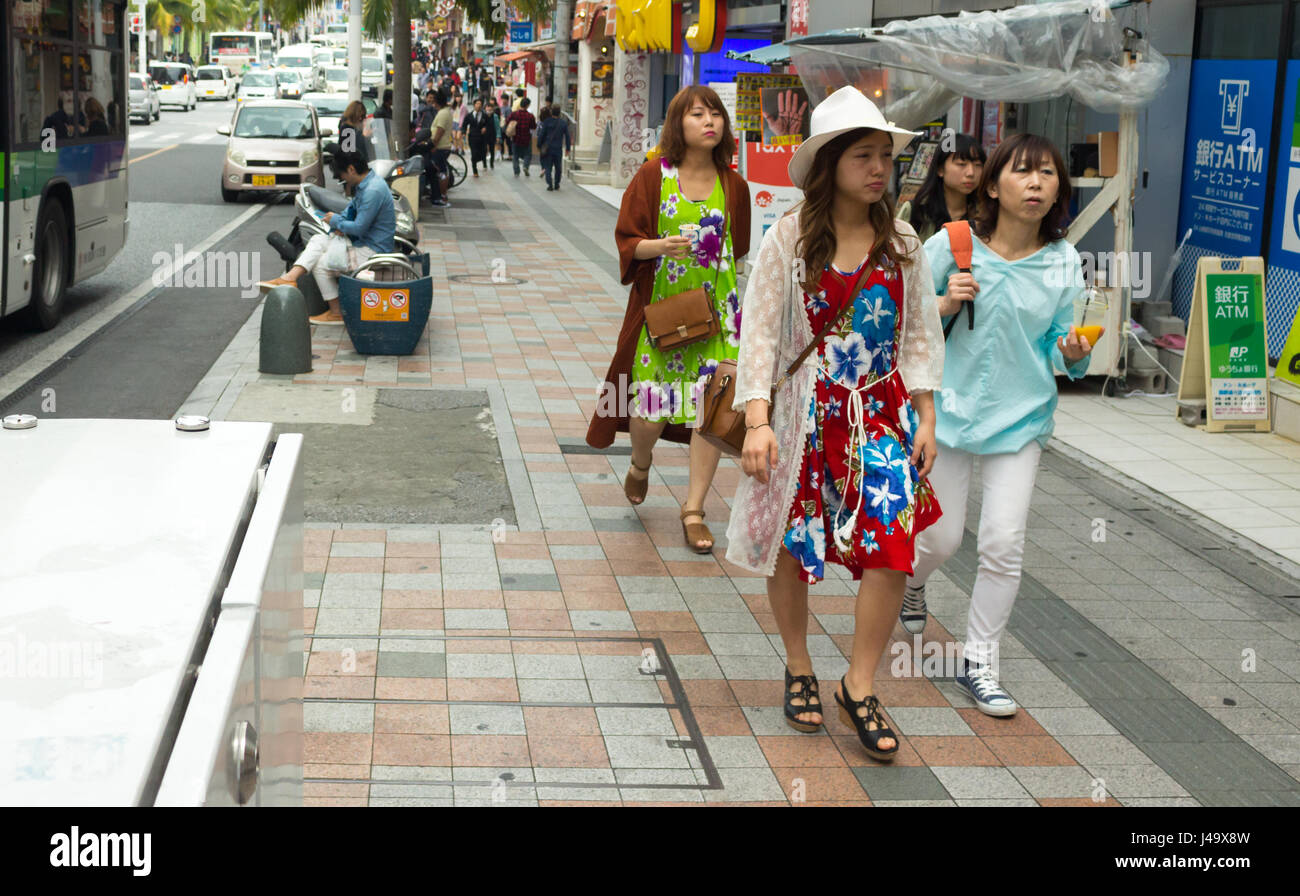Okinawa, Japan - March 24th, 2017: Japanese women walking on the street wearing colorful dresses, Naha, Okinawa. Stock Photo
