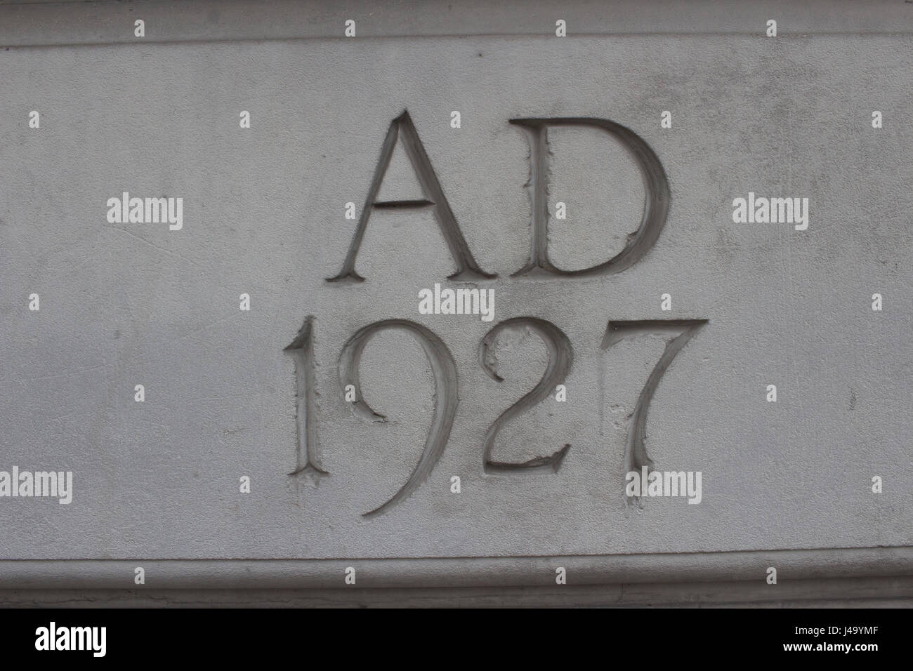 AD 1927 chiseled in stone concrete. Stock Photo