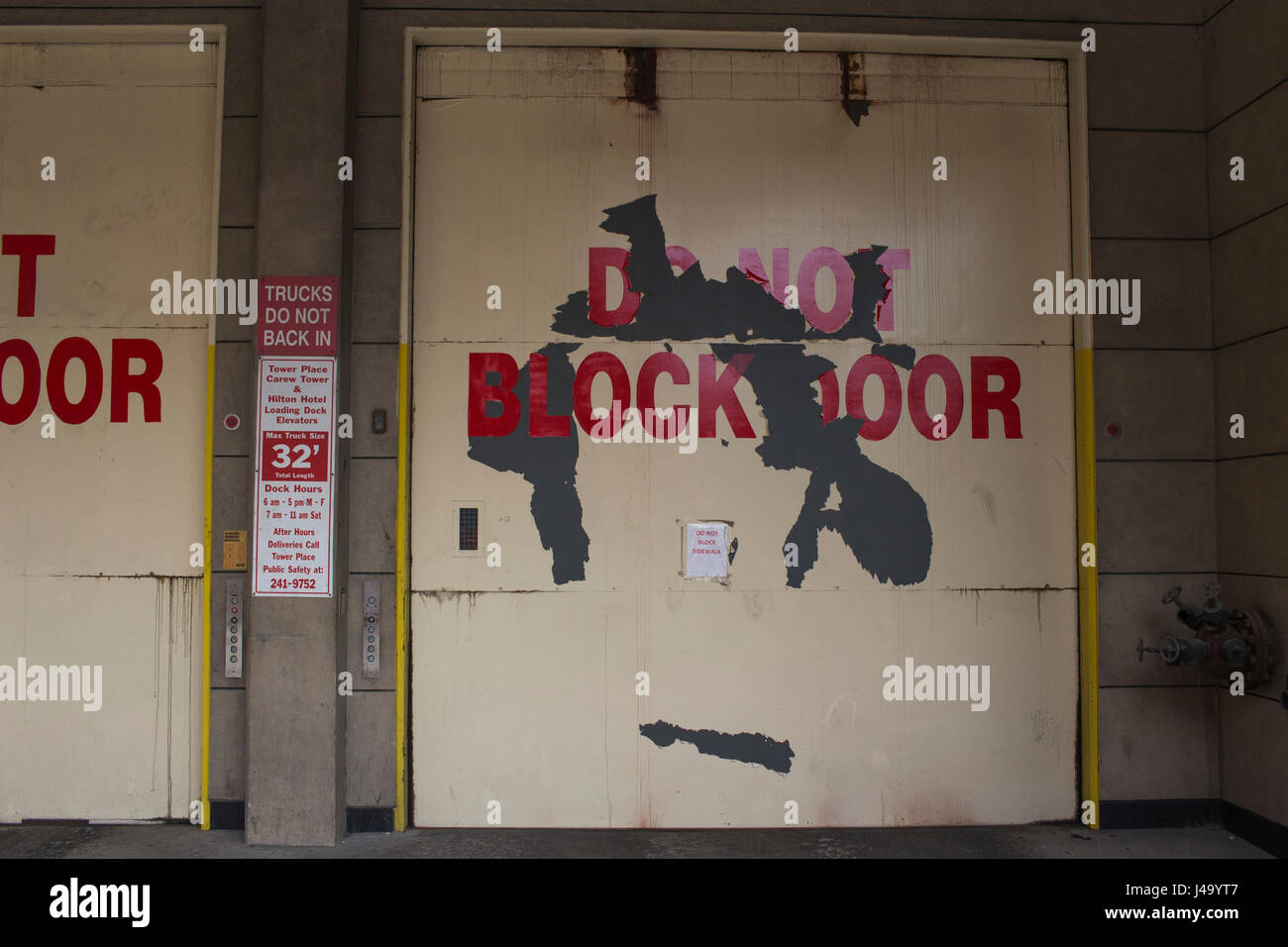 Garage door that reads do not block door in bold red letters. Stock Photo
