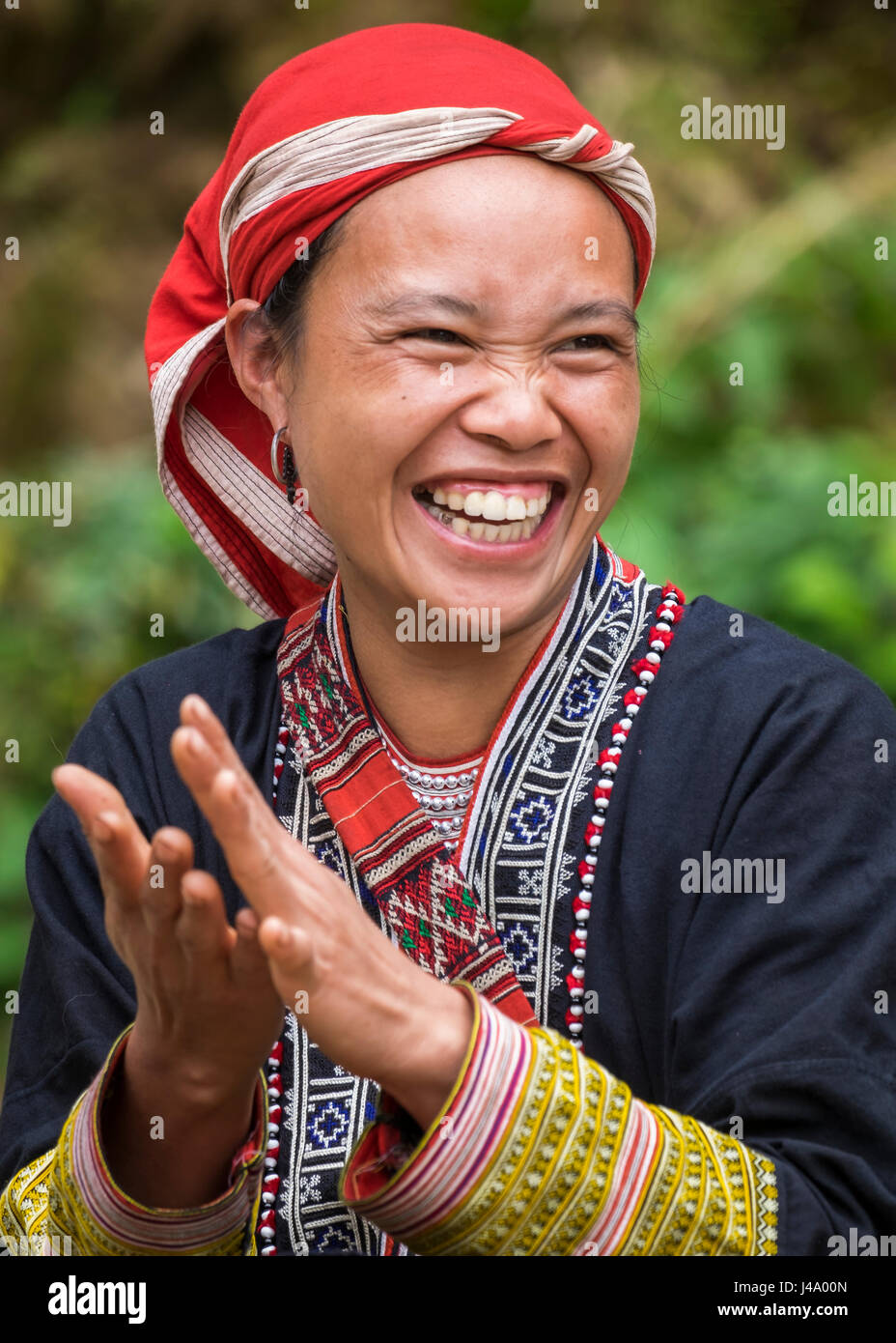 SAPA, VIETNAM - CIRCA SEPTEMBER 2014:  Young woman from the Red Dao minority smiling in Ta Phin Village near Sapa, north Vietnam. Stock Photo