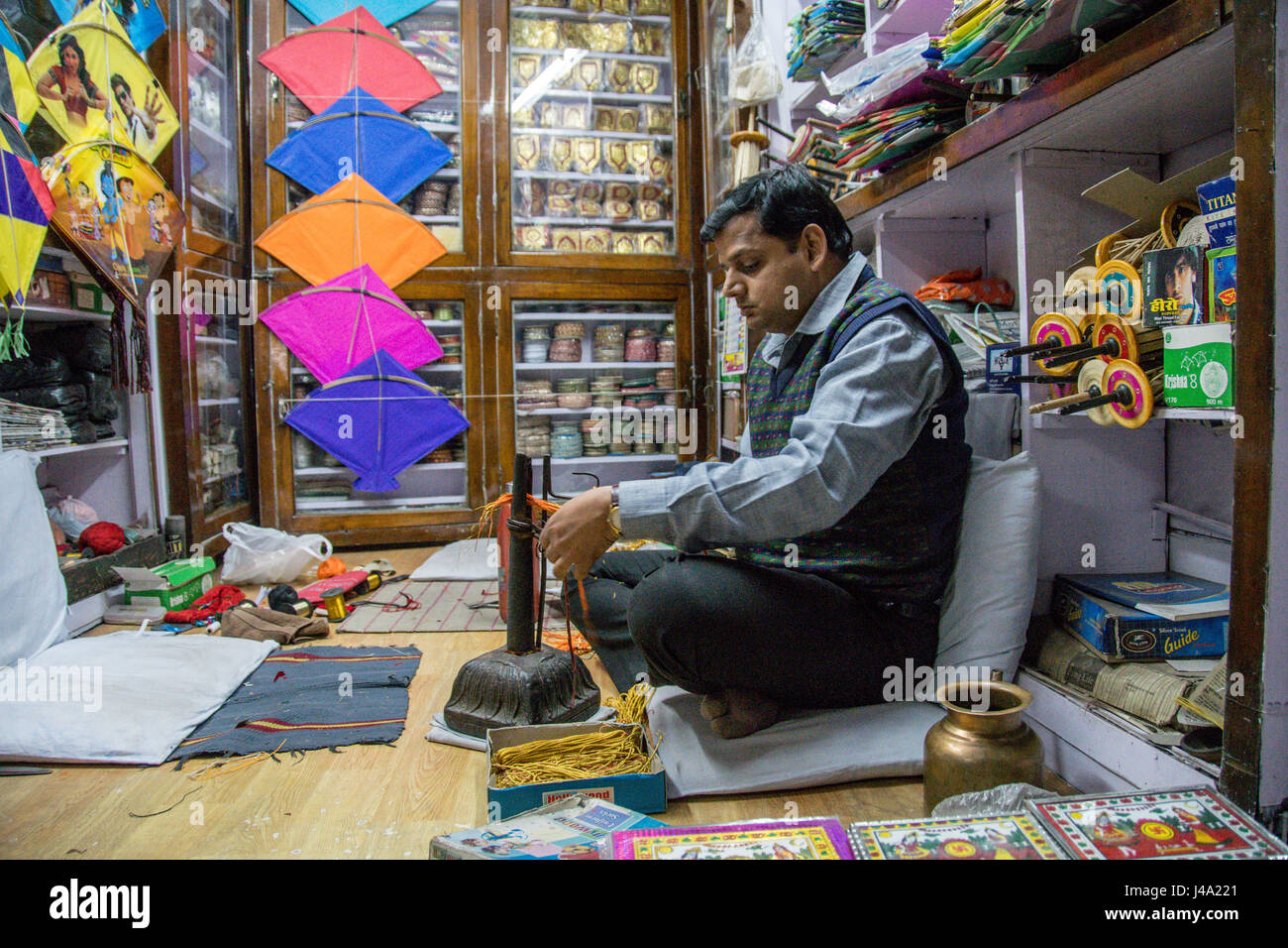 Johri Bazaar; Indian man working in kite shop, Jaipur, India Stock