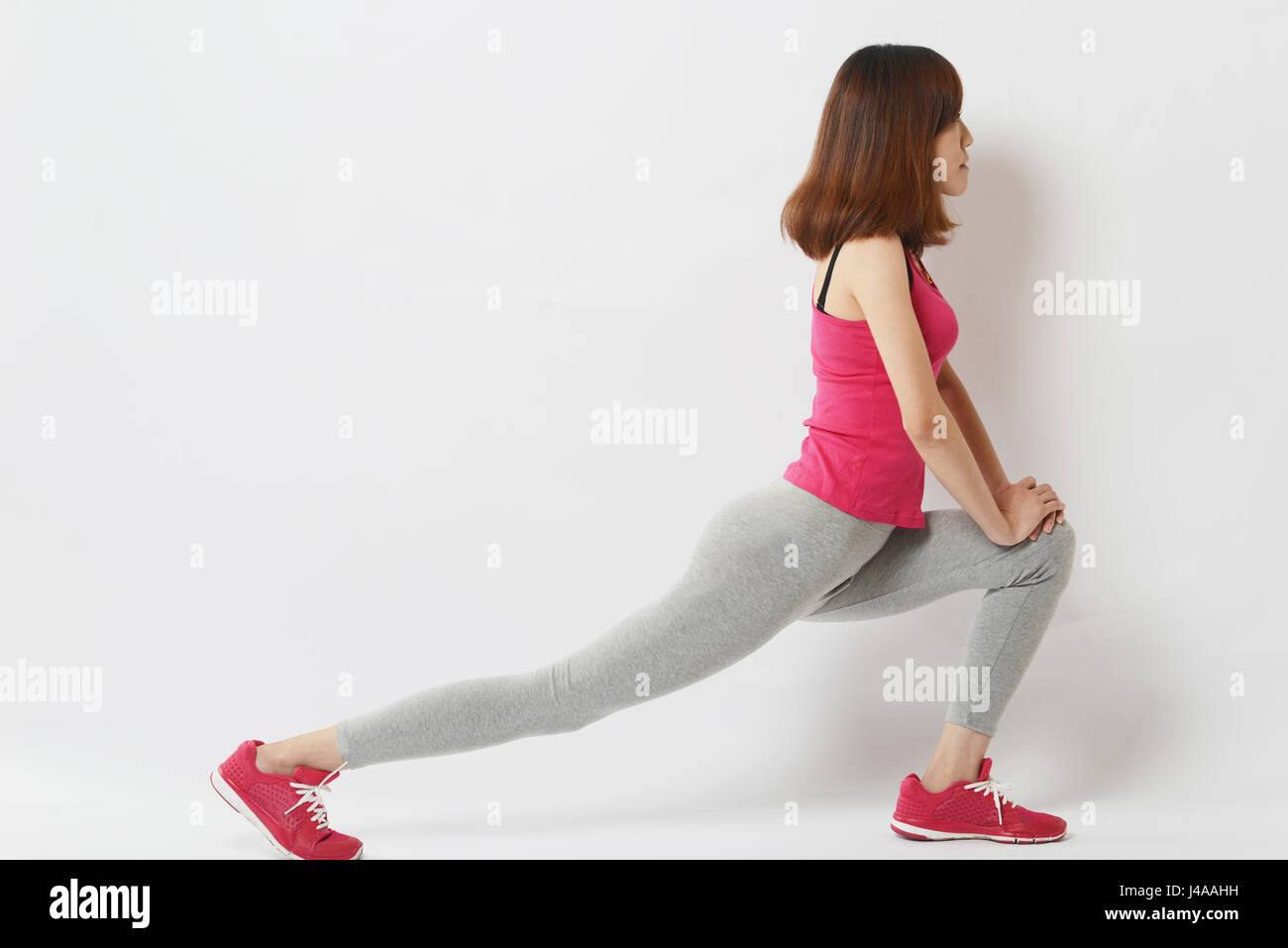 Women doing exercises aerobics warming up with gymnastics for flexibility leg stretching workout Stock Photo