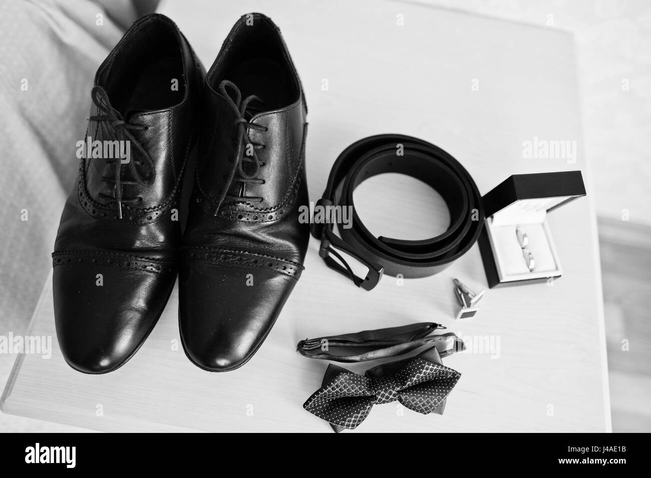 Men's accessories for groom, wedding rings, shoes, belt, cufflinks and bow tie. Stock Photo