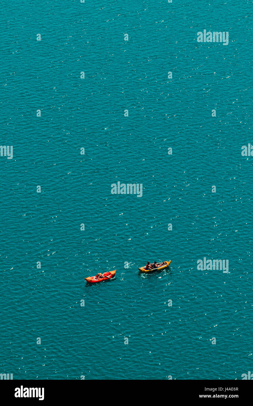 Unrecognizable people enjoying hot summer afternoon in boats on lake Bled, aerial view of leisure and recreational activity for holiday vacation Stock Photo