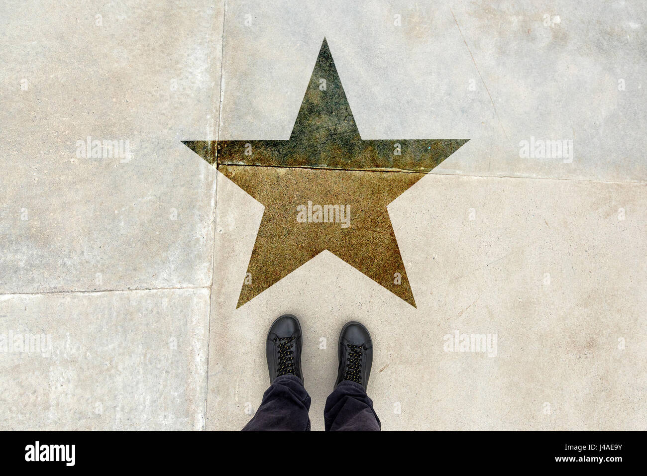 Talented young man on the road with star shape imprint - talent, skill, gifted person, vip, prize and award concept Stock Photo