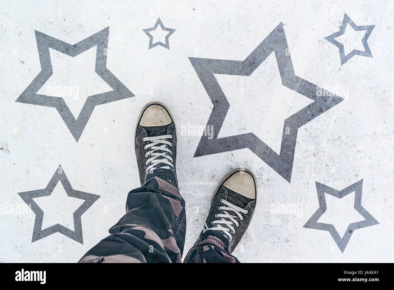 Sneakers on the road with star shape imprint - talent, vip, prize and award concept Stock Photo