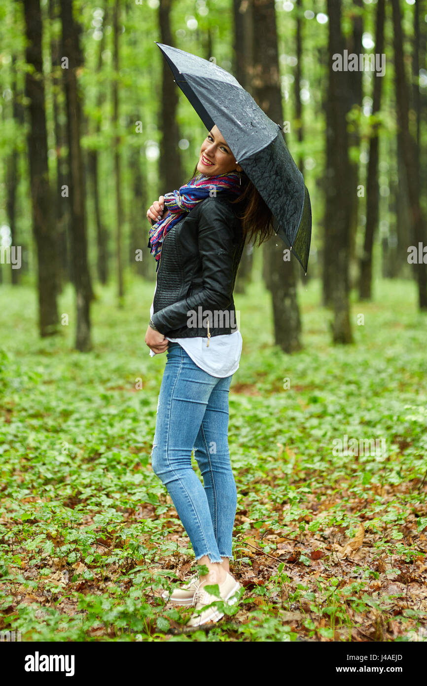 Young woman with umbrella outdoor in the park on a rainy day Stock ...