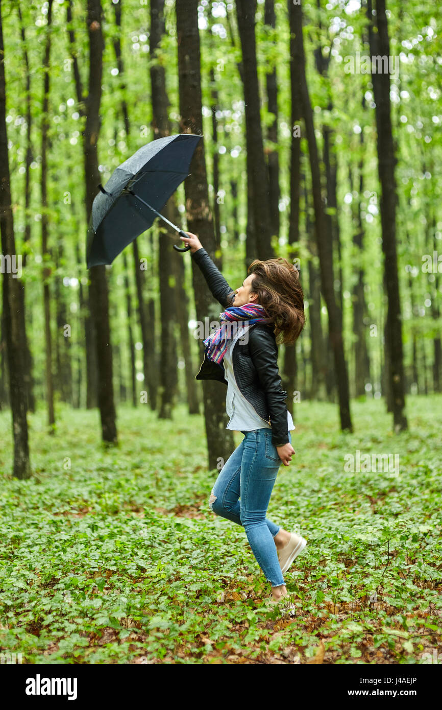 Young woman with umbrella outdoor in the park on a rainy day Stock ...
