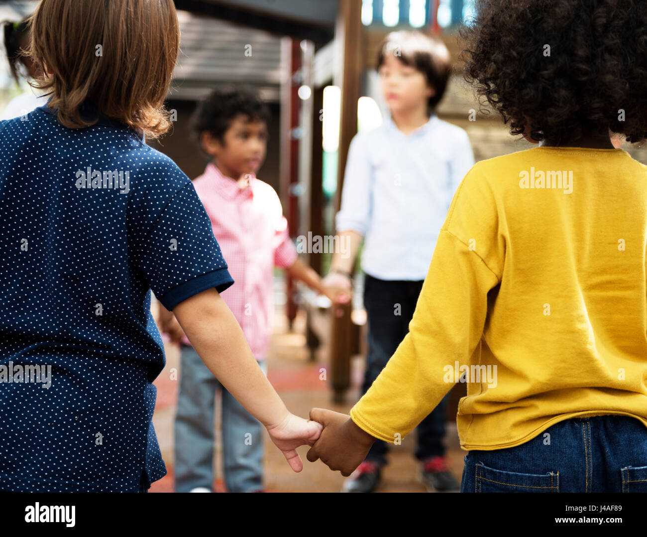  Group of diverse kindergarten students standing holding hands together Illustration 