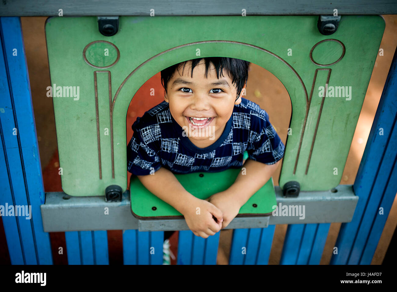 Young boy playing in playground Stock Photo - Alamy