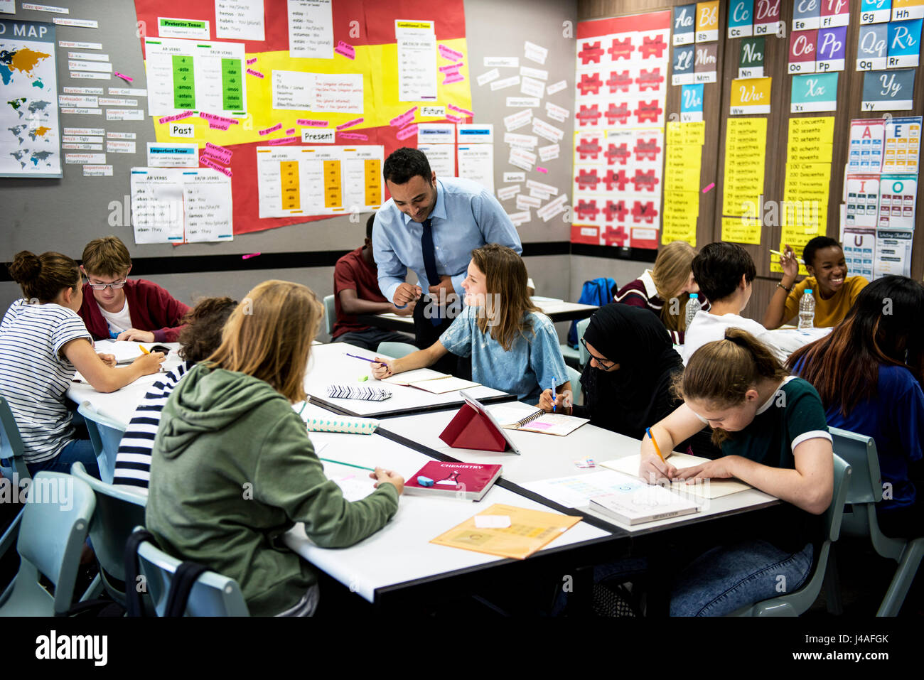 Group of students learning in classroom Stock Photo - Alamy