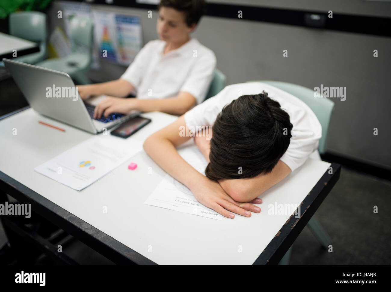 Students in uniform e-learning and sleeping Stock Photo