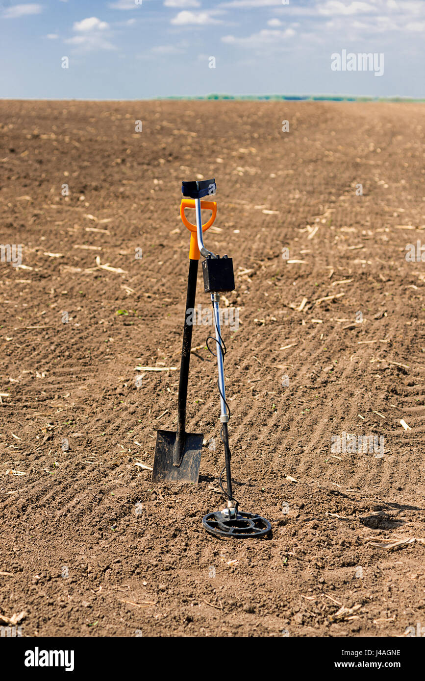 The metal detector and shovel are on the field Stock Photo - Alamy