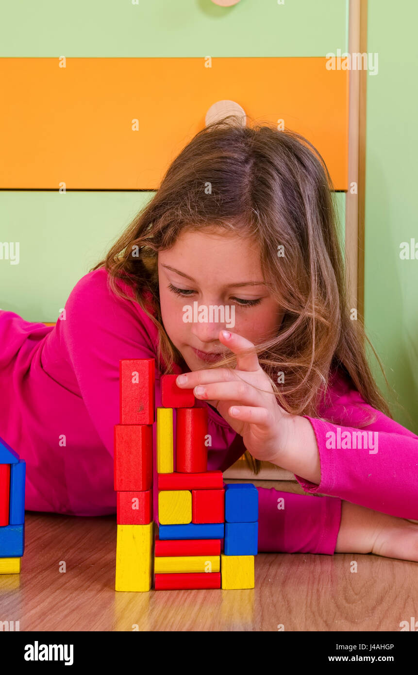 Little girl playing with construction toy blocks Stock Photo - Alamy