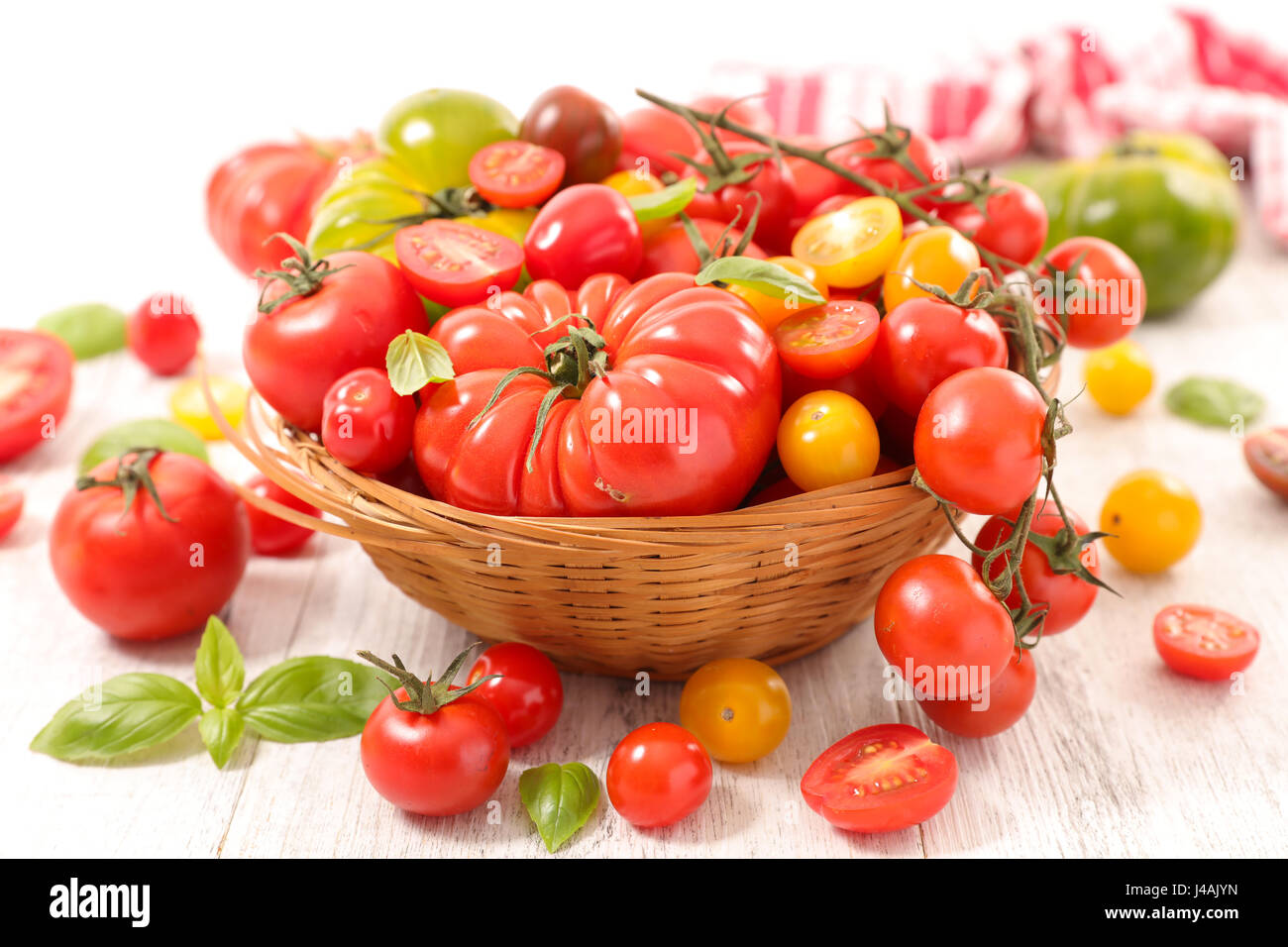 assorted colorful tomatoes in wicker basket Stock Photo - Alamy
