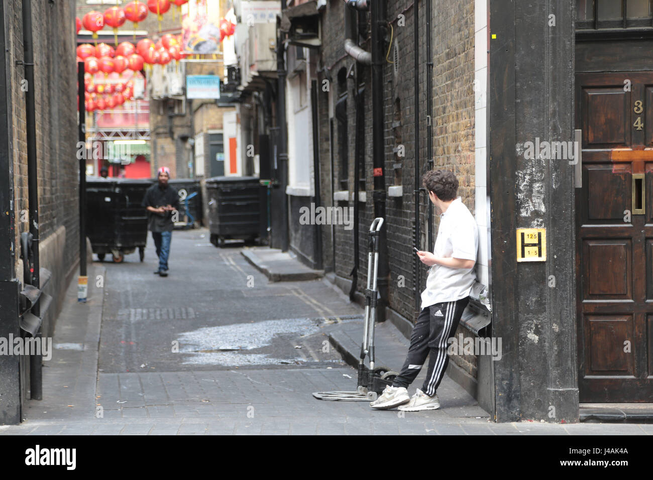 Street Life one back street in Soho watched for ten minutes. Stock Photo