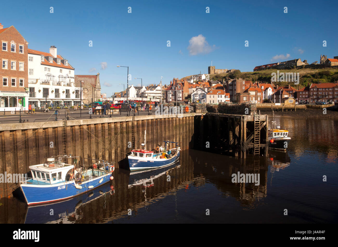 The seaside town of Whitby with the Gothic Whitby Abbey on the hilltop above the town. Yorkshire, England. Stock Photo