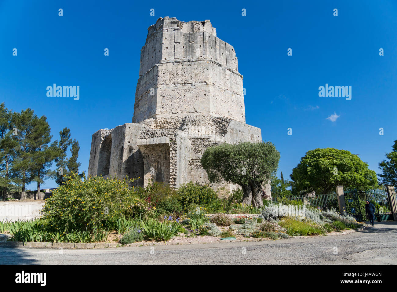 La Tour Magne is a 18m stone watchtower, part of the Roman city wall from the Augustinian era, with panoramic views. Stock Photo