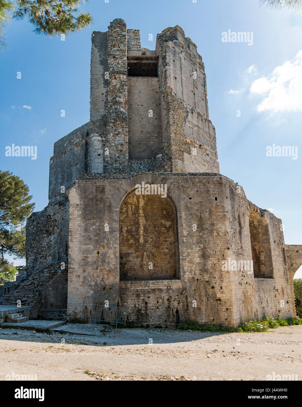 La Tour Magne is a 18m stone watchtower, part of the Roman city wall from the Augustinian era, with panoramic views. Stock Photo