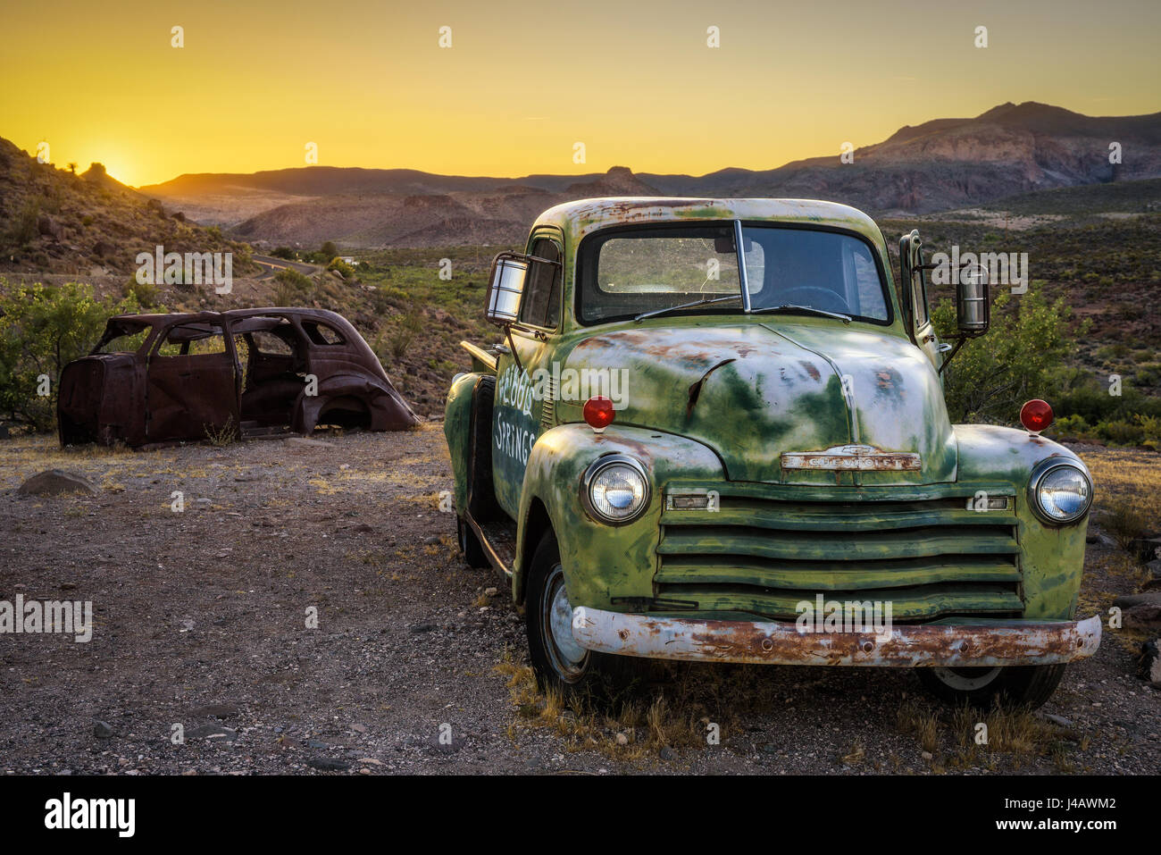 COOL SPRINGS, ARIZONA, USA - MAY 19, 2016: Car wrecks in the Mojave desert on historic route 66 at sunset. Stock Photo