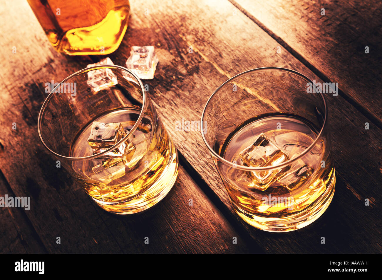 whiskey with ice on old dark wooden table Stock Photo