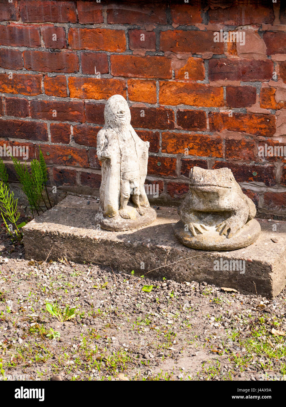 Gnome flasher with frog in garden Stock Photo