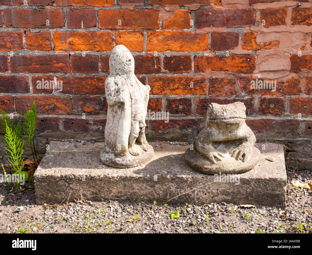 Gnome flasher with frog in garden Stock Photo