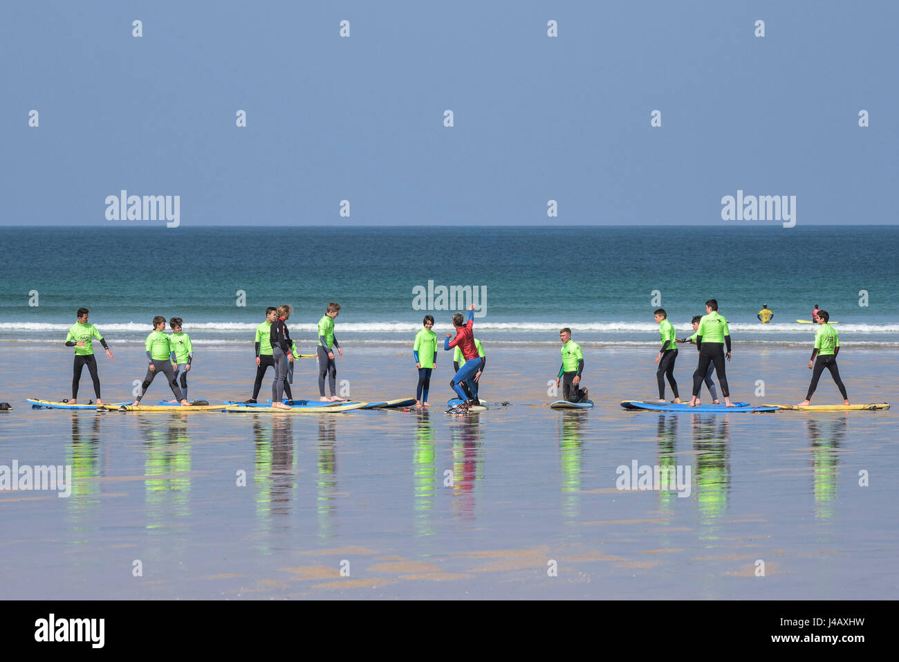 A surf school instructor teaching novices Fistral Beach in Newquay