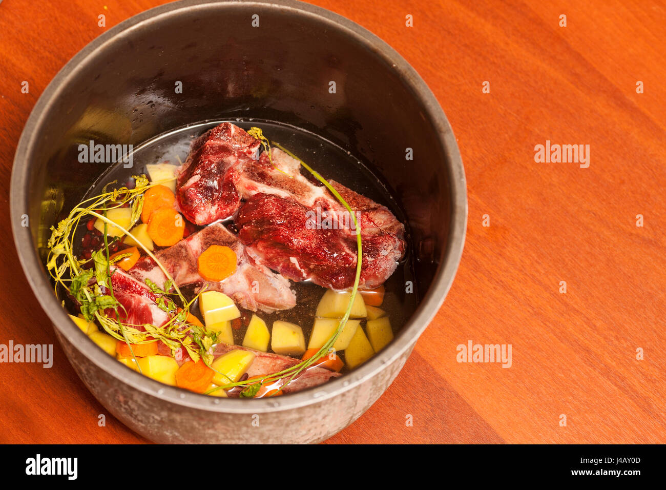 Beef bone bouillon soup cooking Ingredients in saosepan on table Stock
