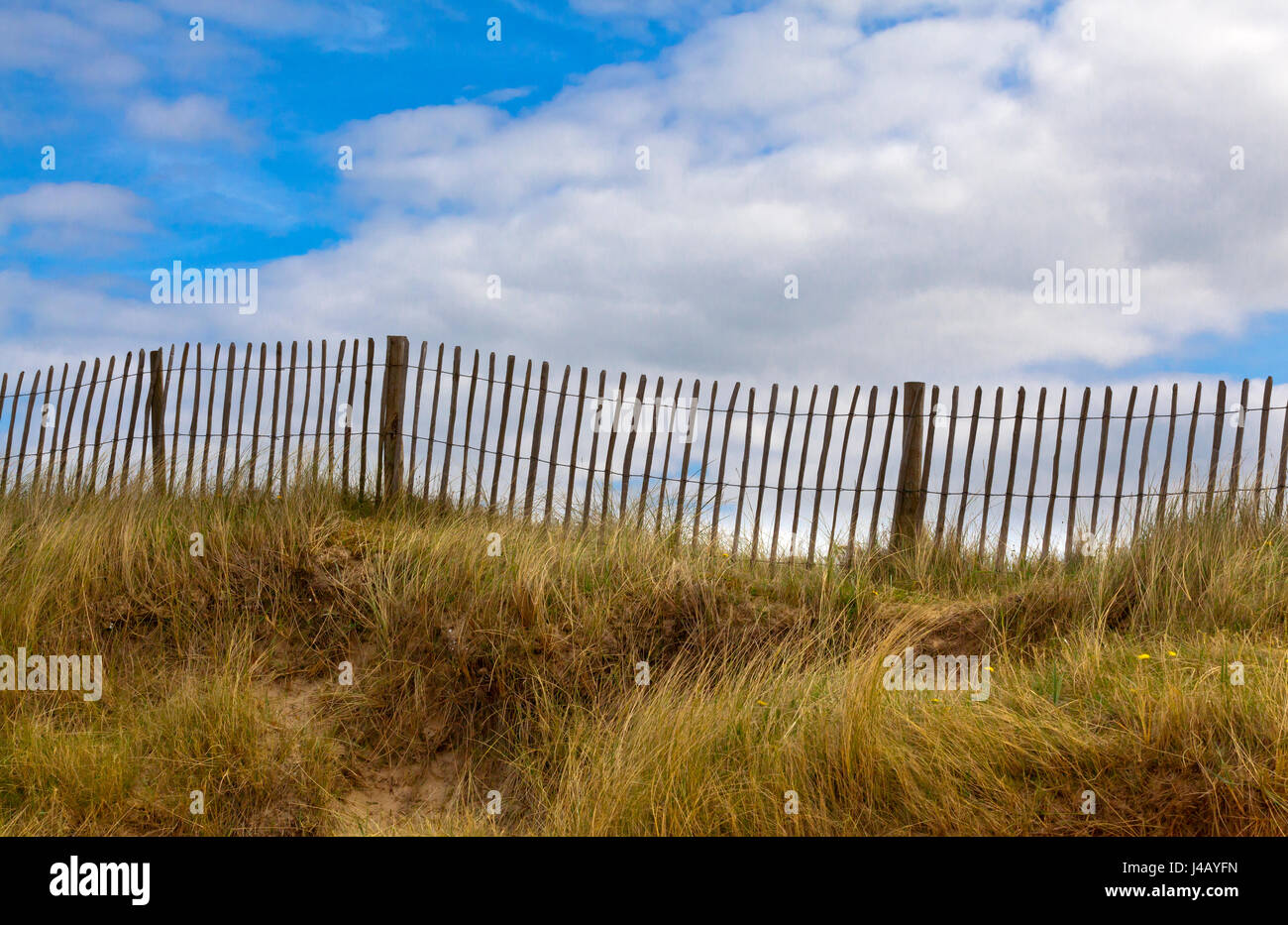 Wooden fence with blue sky and clouds above Stock Photo - Alamy