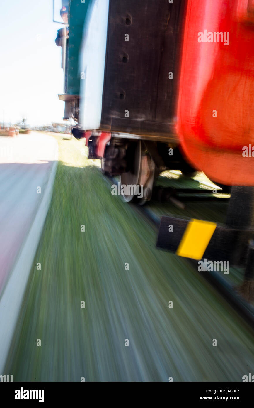 Speedin old fashioned train. Detail shot and speed causes to motion blur. Stock Photo