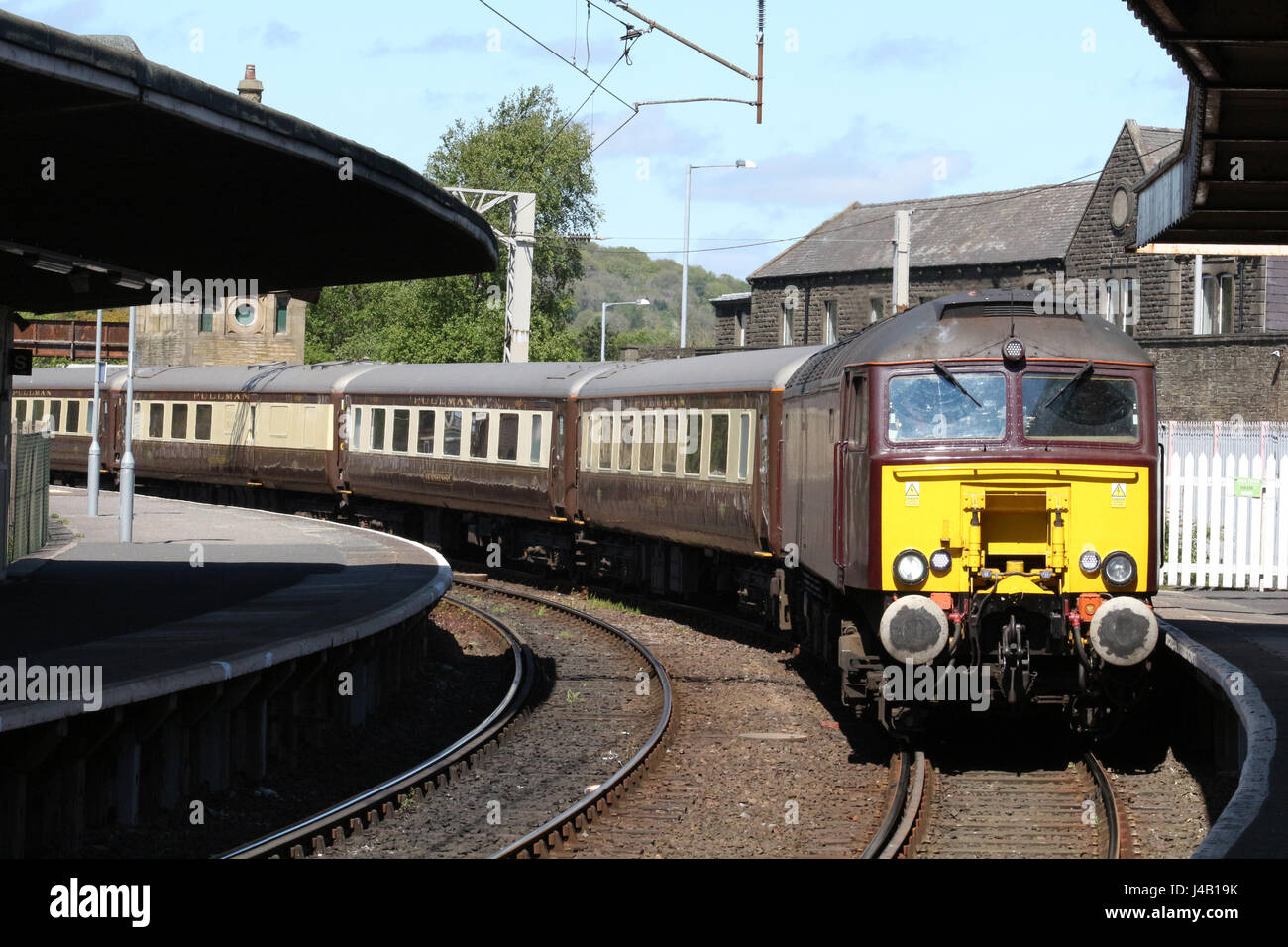 Diesel locomotive in West Coast Railway Company livery hauling empty coaching stock arriving at Carnforth railway station with set of Pullman coaches. Stock Photo
