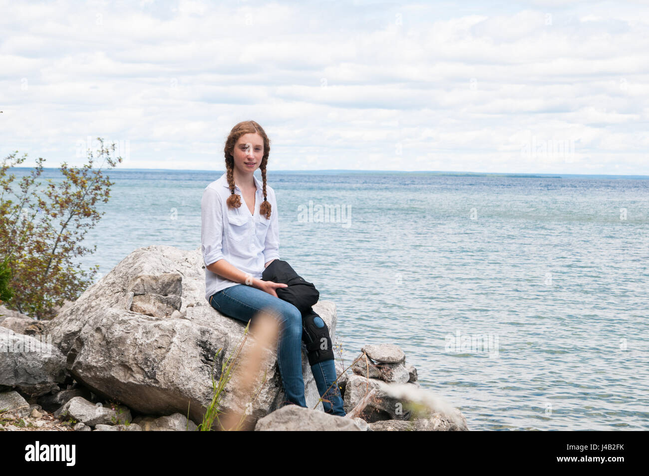 Girl sitting on the rock hi-res stock photography and images - Alamy