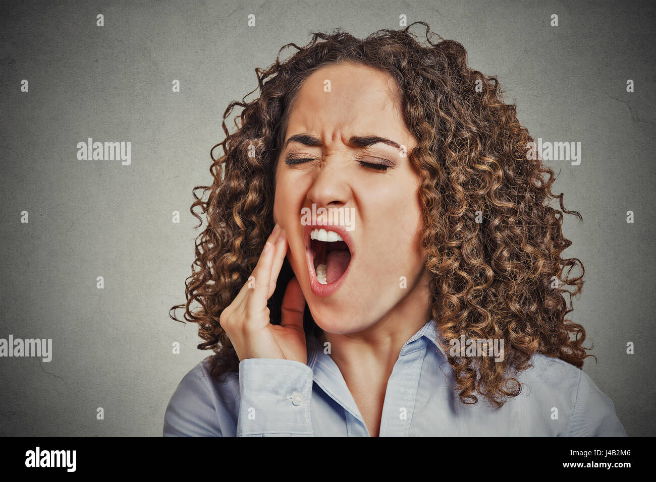 Closeup portrait young woman with sensitive tooth ache crown problem