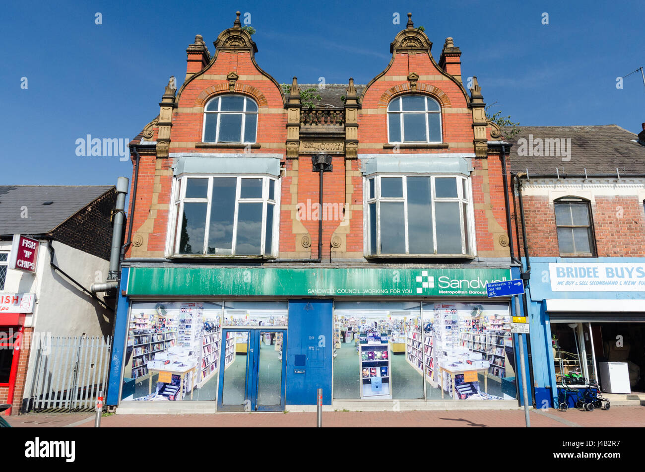 Boarded up shop front in Cradley Heath High Street with large poster depicting shop interior Stock Photo