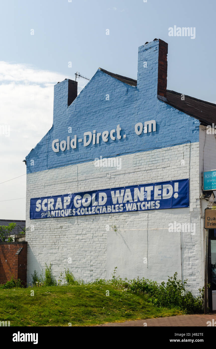 Large sign on building wall saying scrap gold wanted Stock Photo
