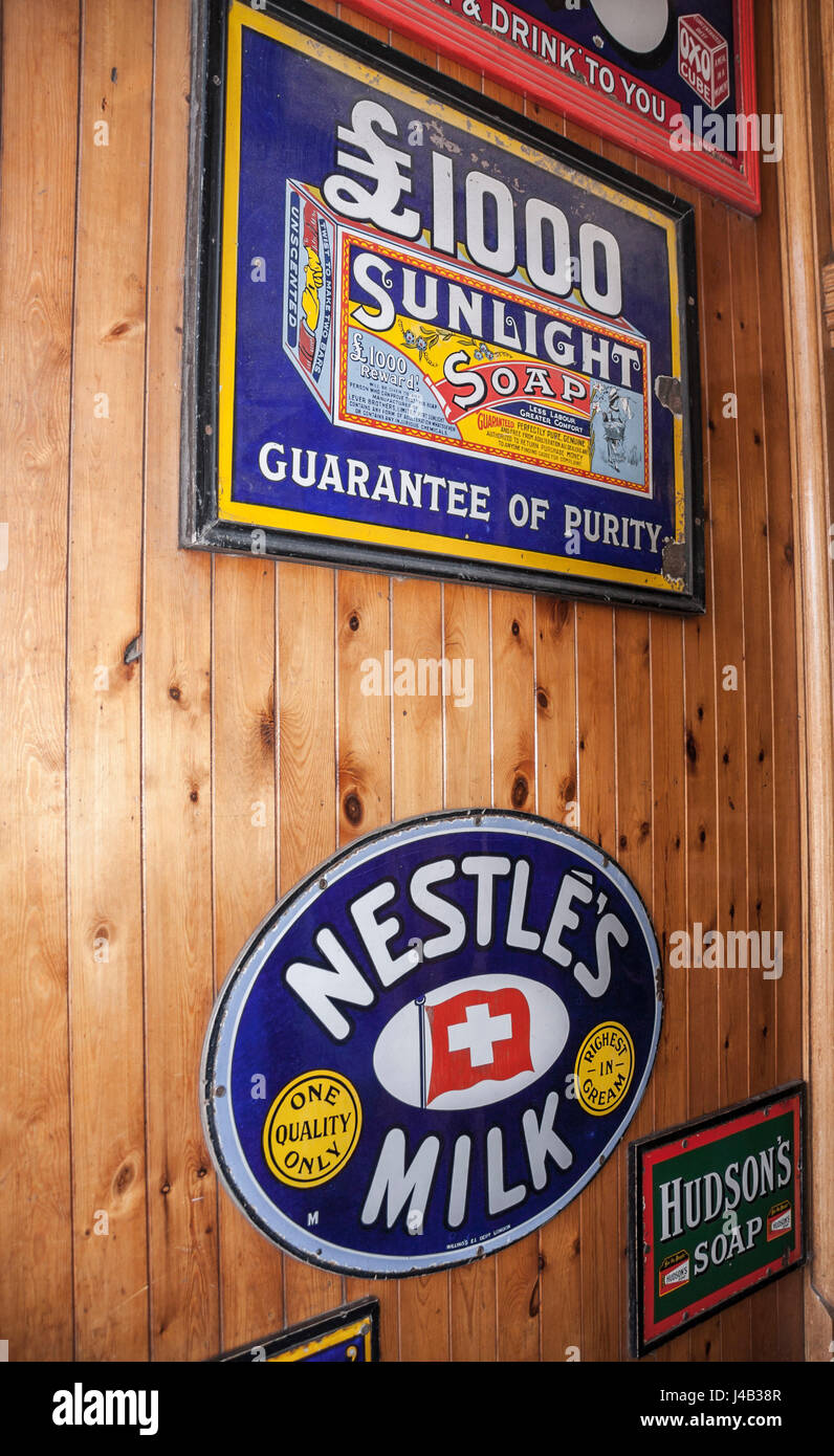 Old signs on the wall in a shop at Beamish Museum,England,UK. Nestles milk,Sunlight soap Stock Photo