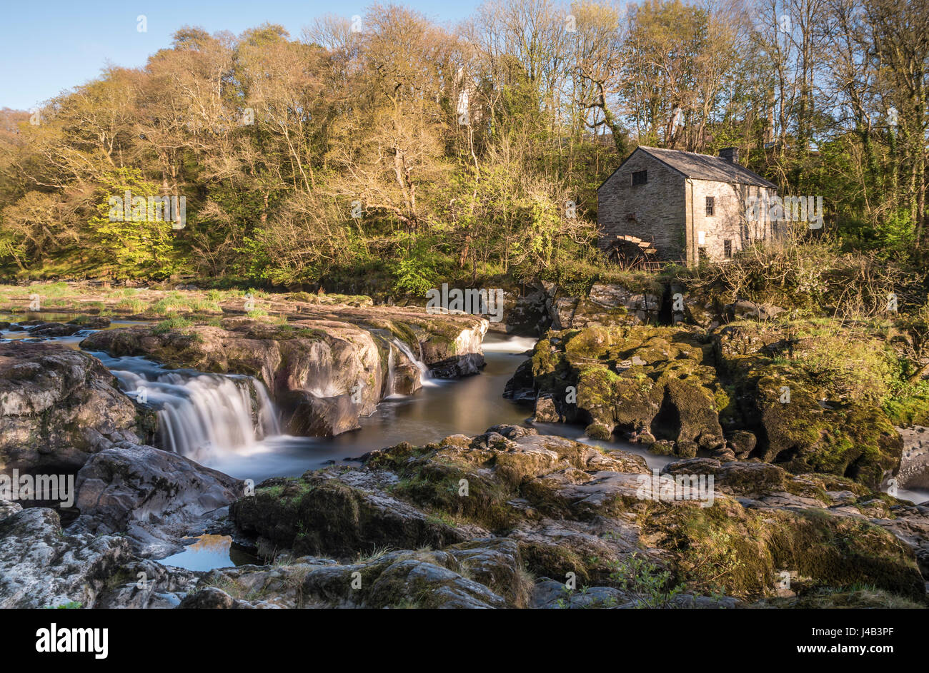 Wide angle long exposure of Cenarth Falls and old water mill, Cenarth, Wales, UK Stock Photo