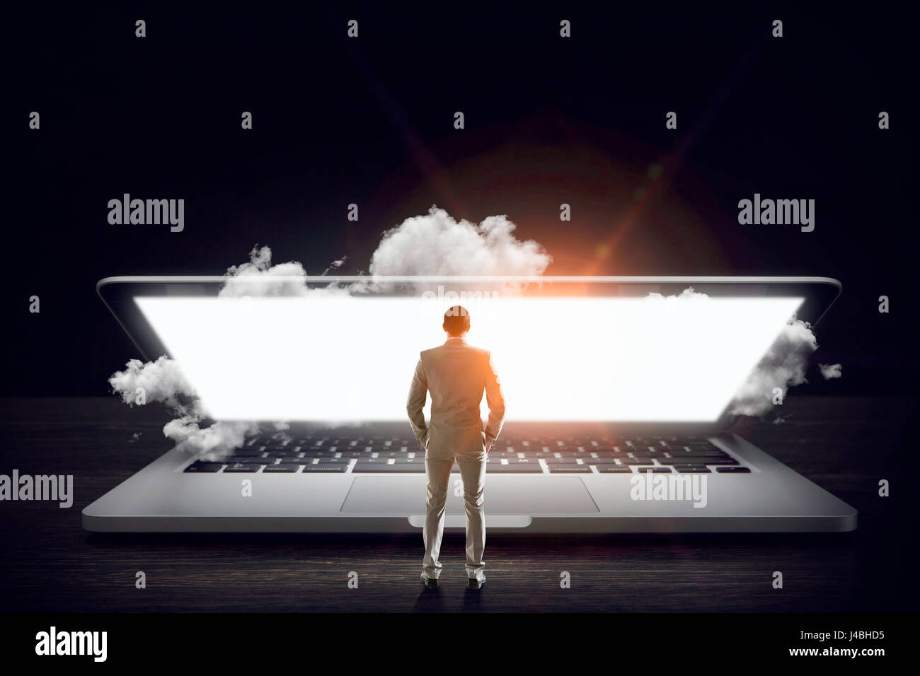 Man on huge laptop Stock Photo - Alamy