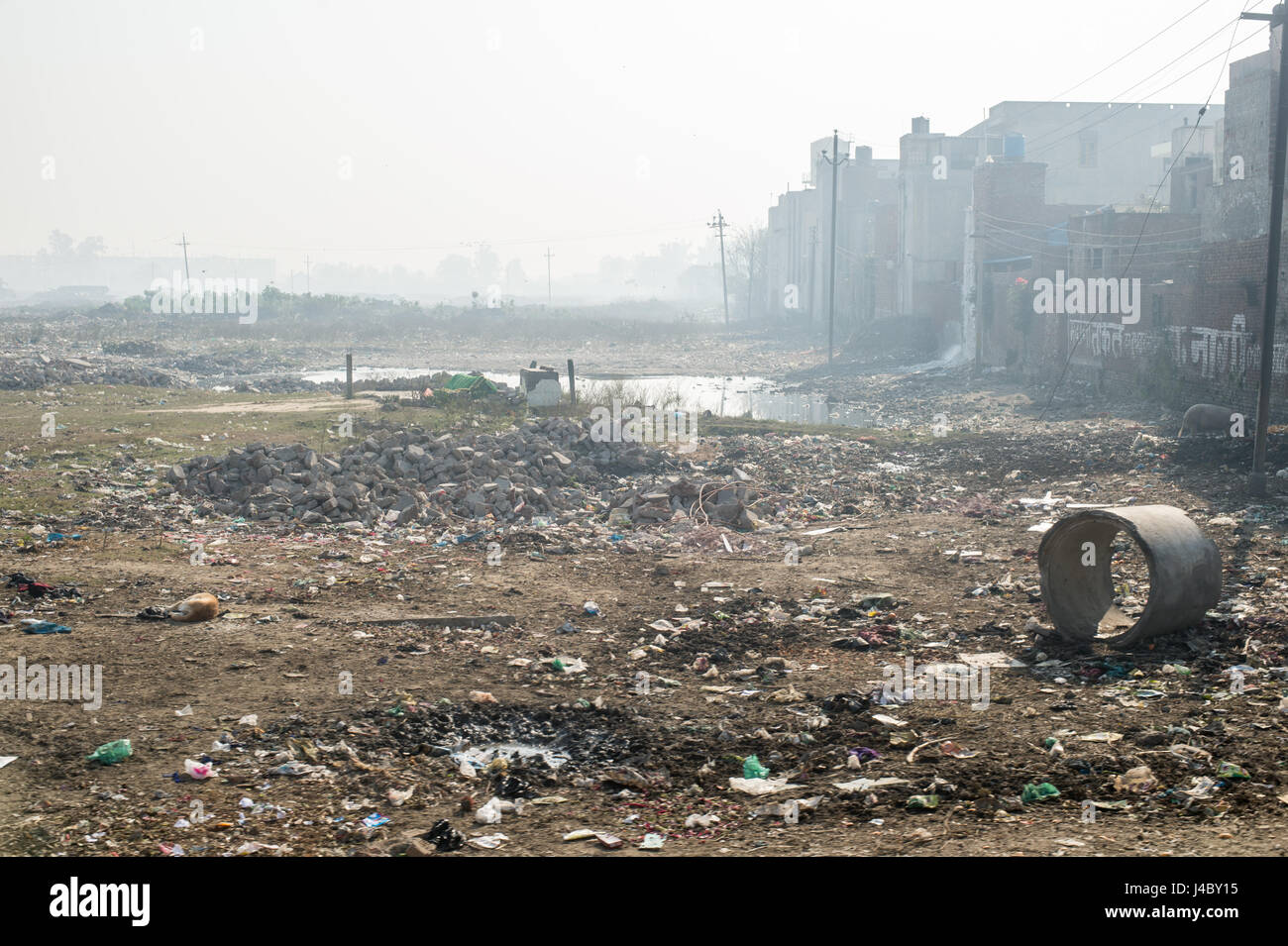 A large field filled with trash and waste in Punjab, India Stock Photo Alamy