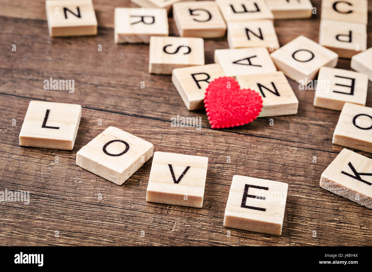 Love message written in wooden blocks with red heart on wooden background  Stock Photo - Alamy