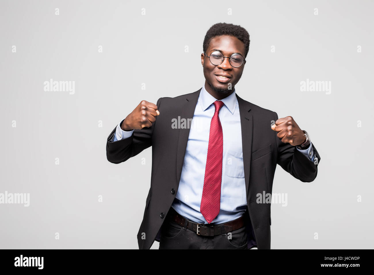 excited businessman with arms raised in success on white background ...