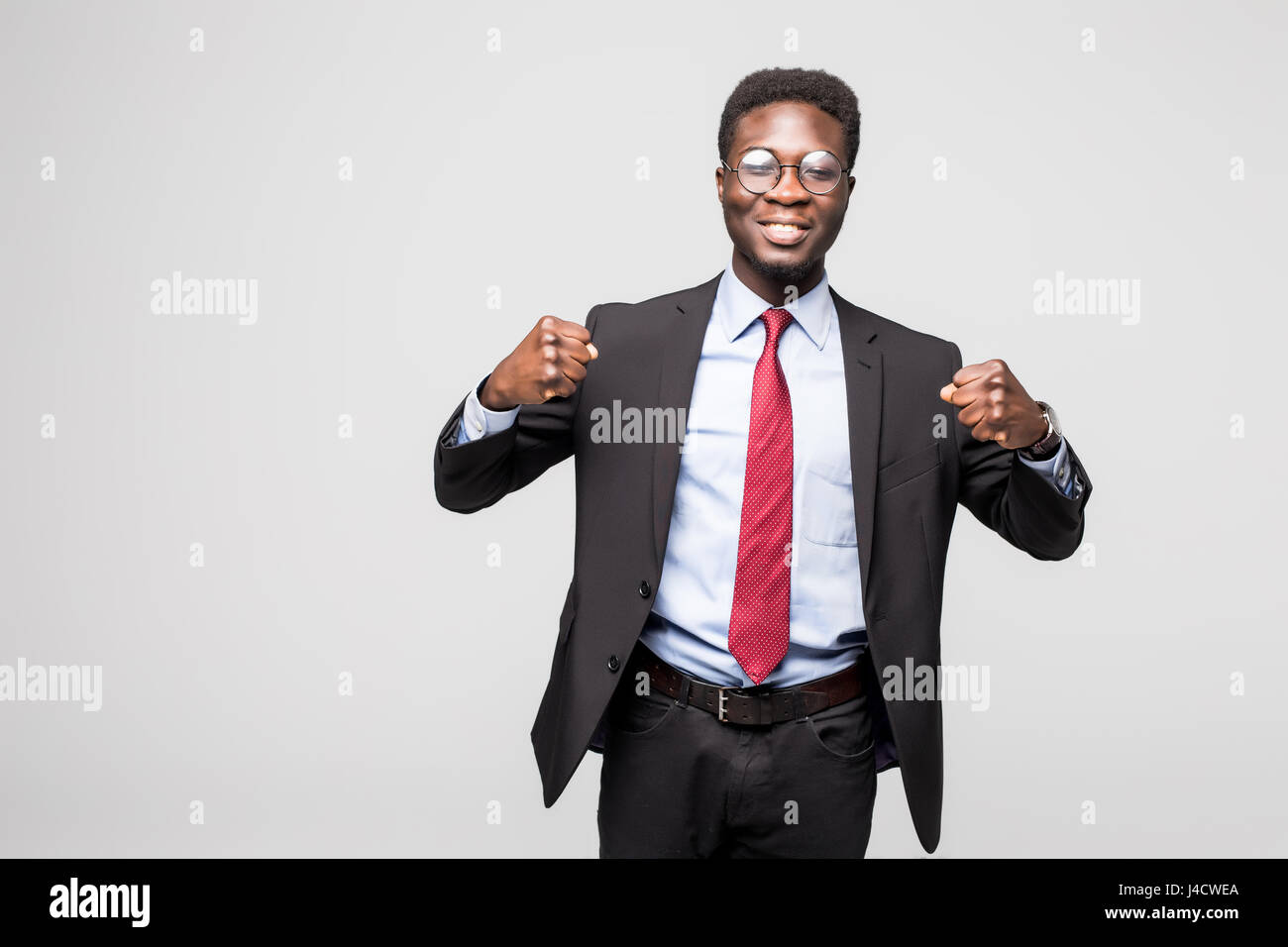 excited businessman with arms raised in success on white background ...