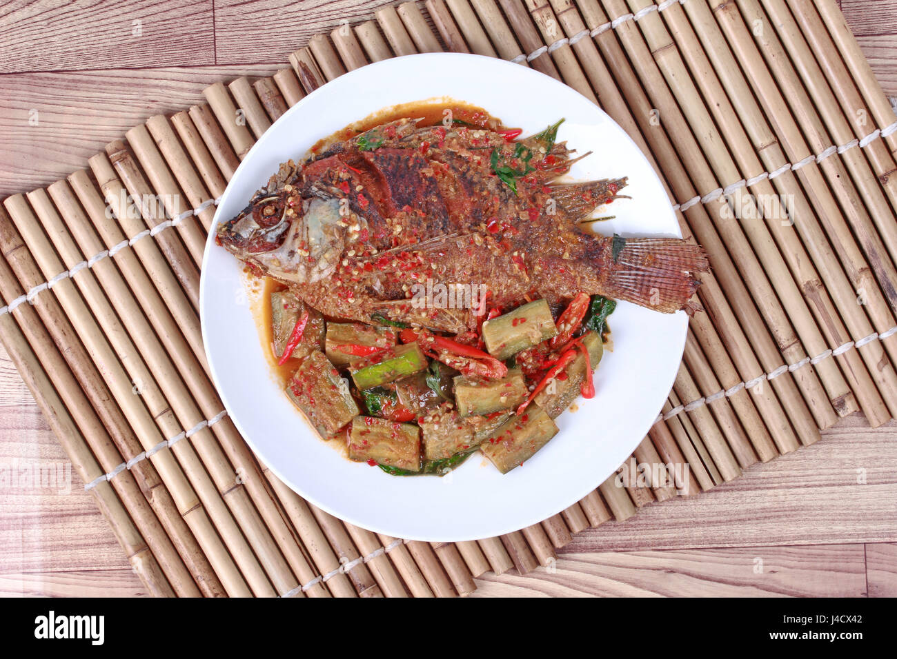 Thai Recipes Deepfried tilapia fish topped Spicy fried eggplant and